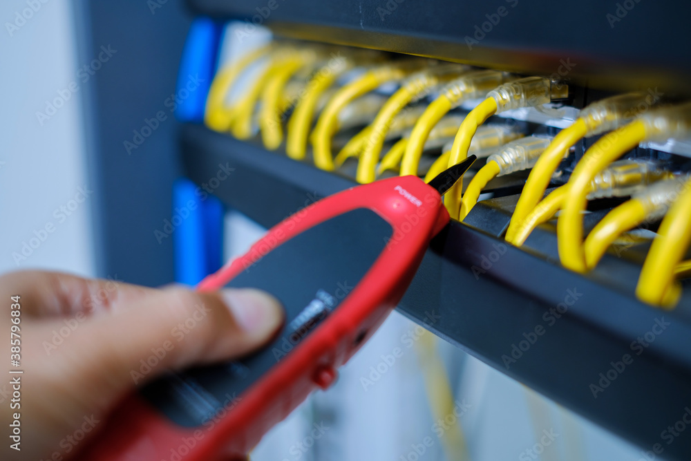 Network tester tools and system administrators will test the network cable in technogy data center room. Network tester tools and system administrators will test the network cable in technogy data center room.
