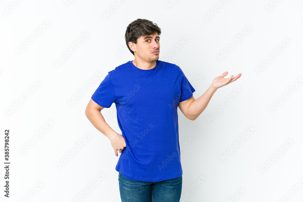 Young cool man doubting and shrugging shoulders in questioning gesture. Young cool man doubting and shrugging shoulders in questioning gesture.