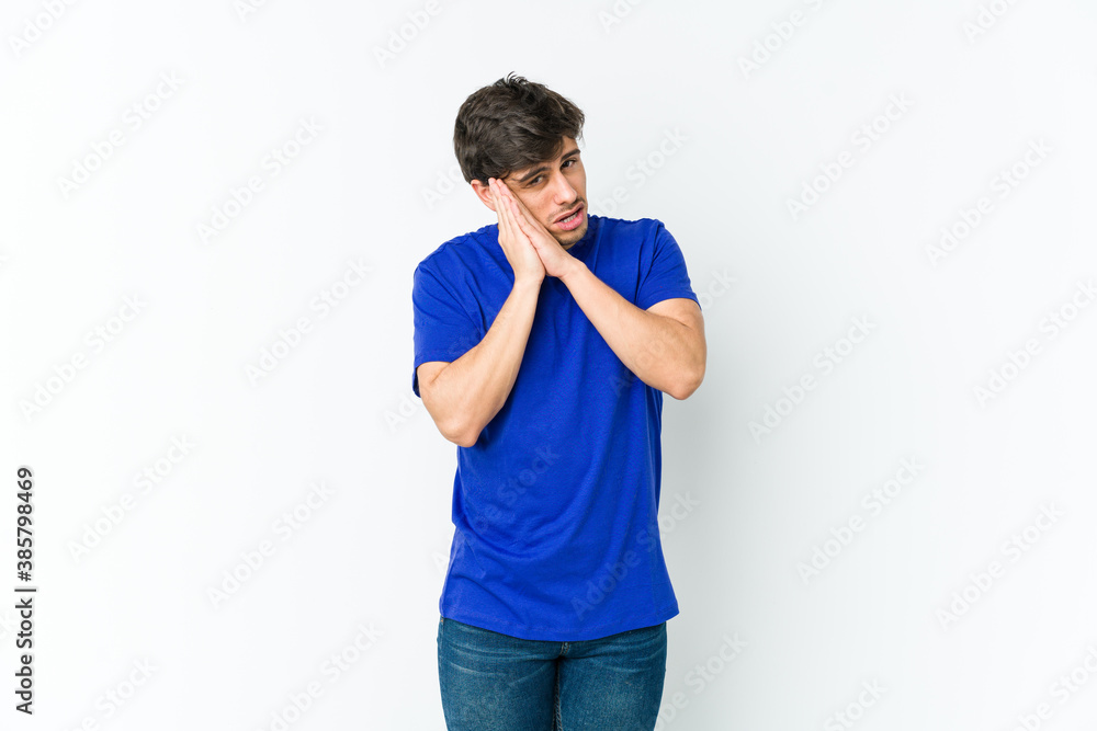 Young cool man yawning showing a tired gesture covering mouth with hand. Young cool man yawning showing a tired gesture covering mouth with hand.