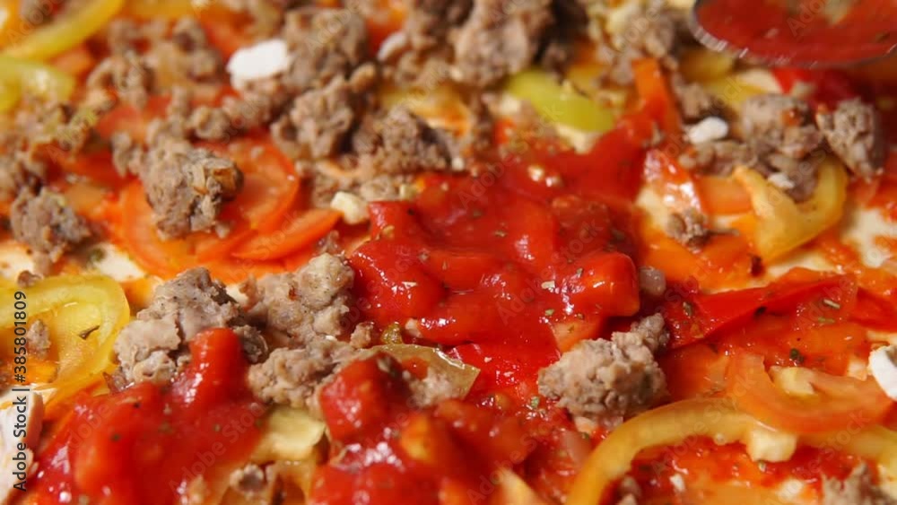 adding tomato sauce to pizza, cooking close-up. selective focus adding tomato sauce to pizza, cooking close-up. selective focus