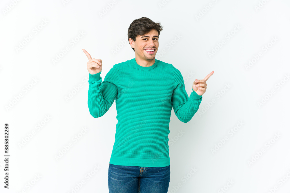 Young cool man pointing to different copy spaces, choosing one of them, showing with finger. Young cool man pointing to different copy spaces, choosing one of them, showing with finger.