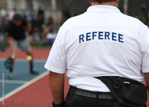 A referee watches play during a pickleball tournament. 