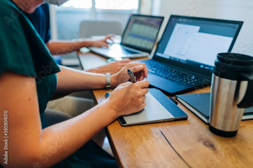 Female professional using graphics tablet at office