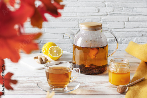 Tea with lemon, ginger and honey on white wooden table. Alternative medicine.