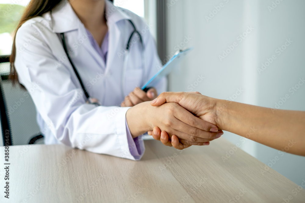 Doctors and patients shaking hands after knowing the results of the health examination, medical checkup concept Doctors and patients shaking hands after knowing the results of the health examination, medical checkup concept