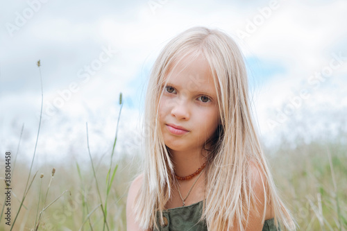 Portrait of blond girl in field photo