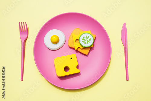 Three dimensional render of plastic plate with bread, cheese and fried egg photo