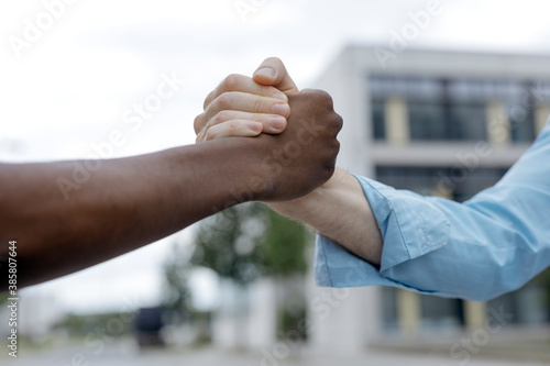 Cropped image of friends bonding in city photo