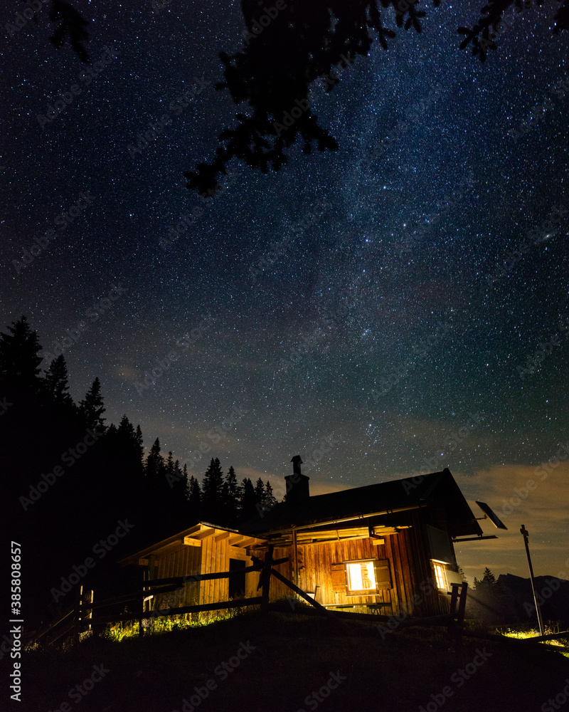 Starry night sky over secluded mountain hut Starry night sky over secluded mountain hut