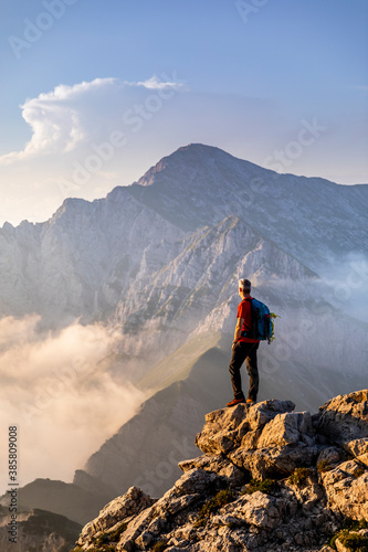 Hiker standing while admiring view of mountain at Bergamasque Alps, Italy © 27exp/Westend61