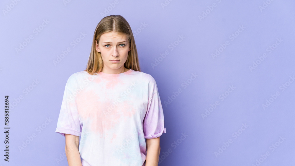 Young blonde woman isolated on purple background sad, serious face, feeling miserable and displeased. Young blonde woman isolated on purple background sad, serious face, feeling miserable and displeased.