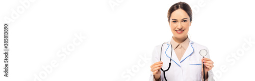 Panoramic shot of doctor in white coat holding stethoscope isolated on white