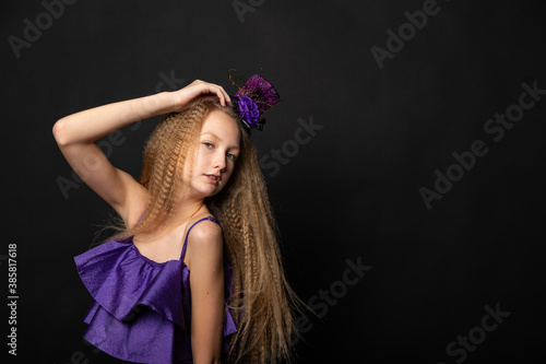 Teenage girl on black background of Halloween © MARIYA