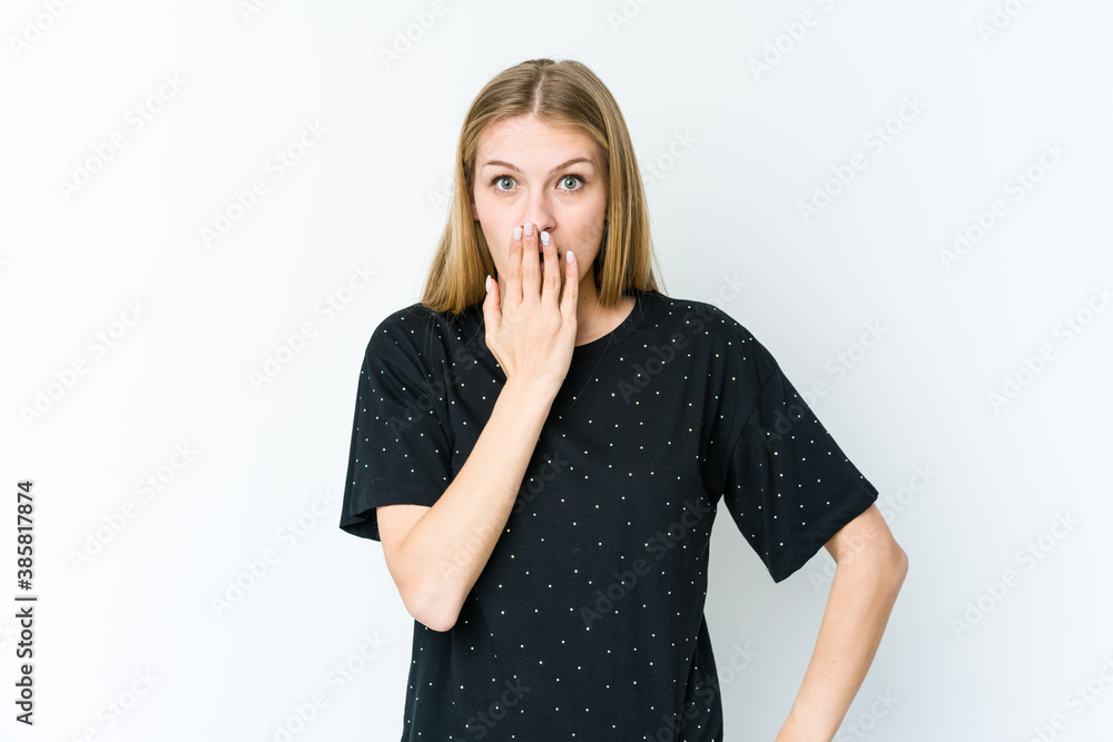 Young blonde woman isolated on white background shocked, covering mouth with hands, anxious to discover something new. Young blonde woman isolated on white background shocked, covering mouth with hands, anxious to discover something new.