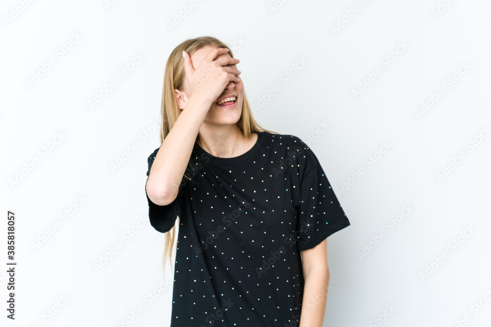 Young blonde woman isolated on white background laughs joyfully keeping hands on head. Happiness concept. Young blonde woman isolated on white background laughs joyfully keeping hands on head. Happiness concept.