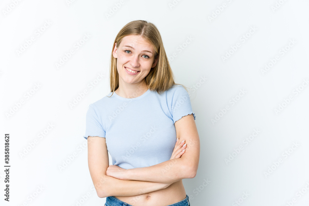Young blonde woman isolated on white background who feels confident, crossing arms with determination.