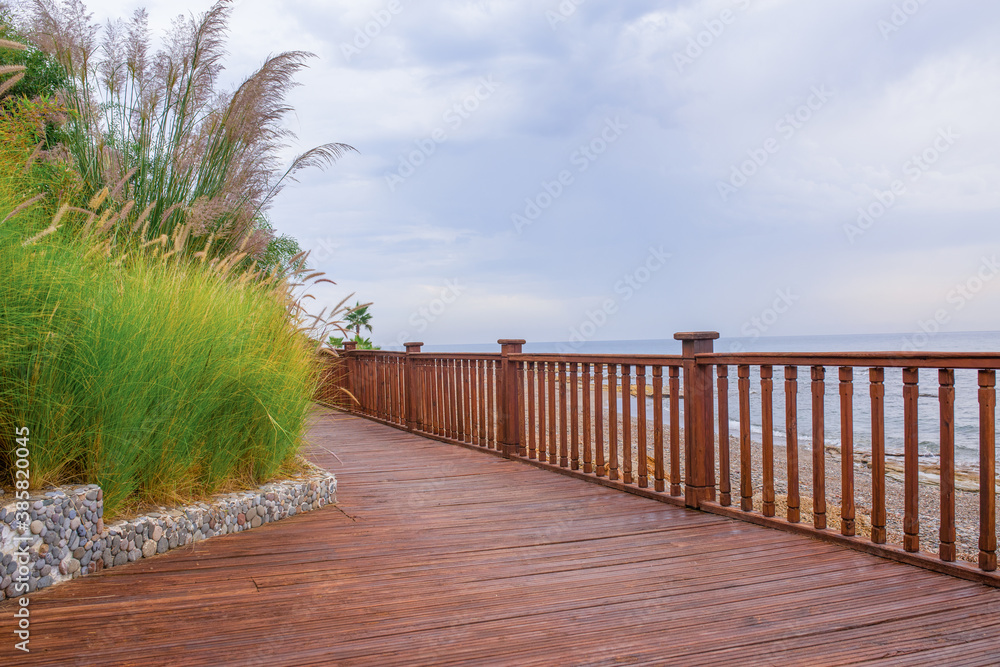 Wooden Promenade. Seaside promenade tourist destination Side, wooden boardwalk. Wooden deck floor sea waterfront perspective. Side Turkey