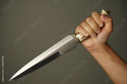 Konstfotografi the man is holding a large double-edged knife with a bone handle