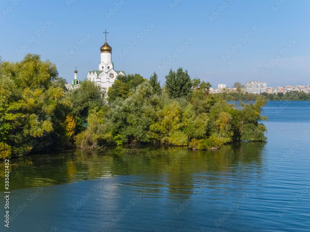 christian church on a river island among a park trees