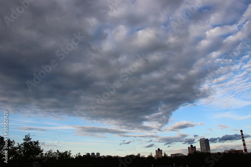 Blue Sky in evening with clouds. Big city buildings silhoutes panorama. City life concept photo