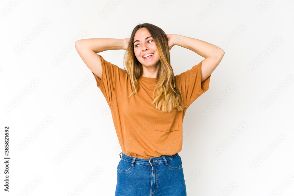 Young caucasian woman isolated on white background feeling confident, with hands behind the head. Young caucasian woman isolated on white background feeling confident, with hands behind the head.