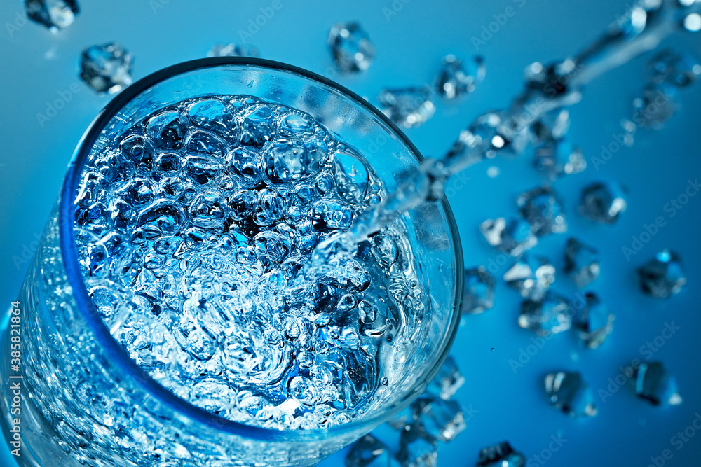 Mineral water is poured into a glass. Mineral water is poured into a glass.