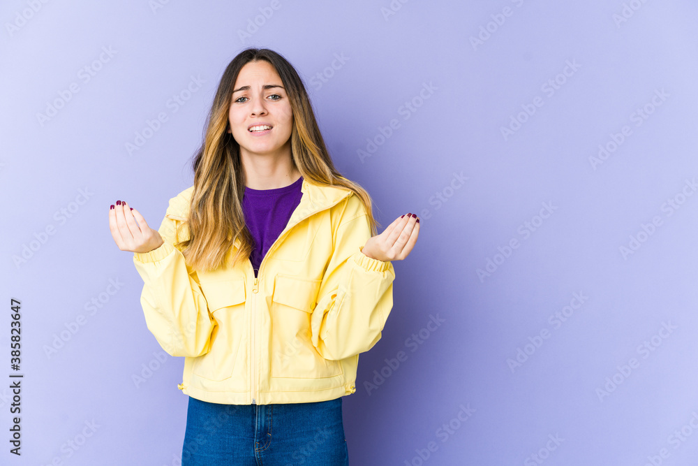 Young caucasian woman isolated on purple background showing that she has no money. Young caucasian woman isolated on purple background showing that she has no money.