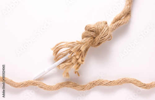 close-up of a brown strong rope, tie with smoking