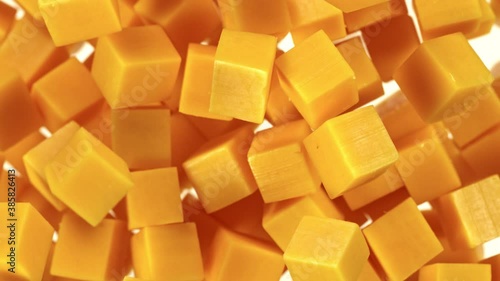 Super Slow Motion Shot of Flying Cheddar Cheese Cubes at 1000 fps. photo