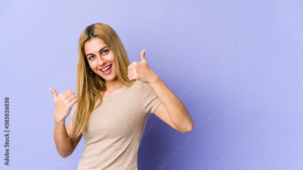 Fototapeta premium Young blonde caucasian woman raising both thumbs up, smiling and confident.