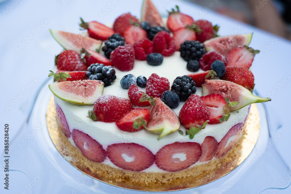 Beautiful fresh yogurt and strawberry cake with summer berries Beautiful fresh yogurt and strawberry cake with summer berries
