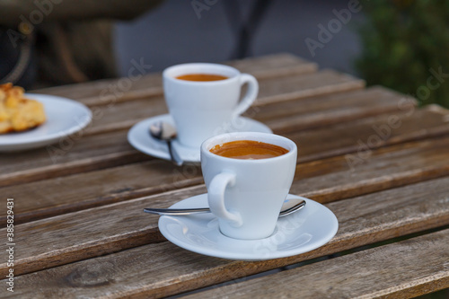 Cup of coffee on table in coffee shop cafe.A cup of coffee and coffee beans with croissant on the table