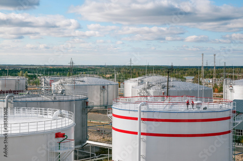 Cloudy day. Tanks with oil for further transportation of oil through pipes at an oil refinery and oil pumping station