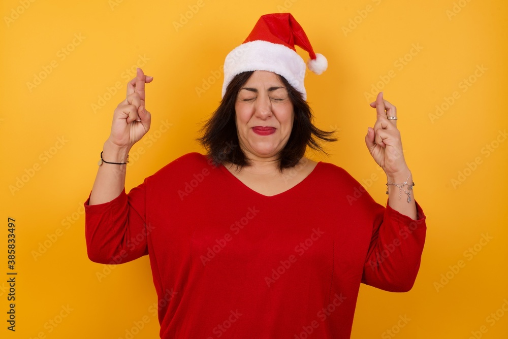 I have to win. Joyful young brunette female clenches teeth, raises fingers crossed, makes desirable wish, wears casual clothes, waits for good news, stands indoor over gray wall I have to win. Joyful young brunette female clenches teeth, raises fingers crossed, makes desirable wish, wears casual clothes, waits for good news, stands indoor over gray wall