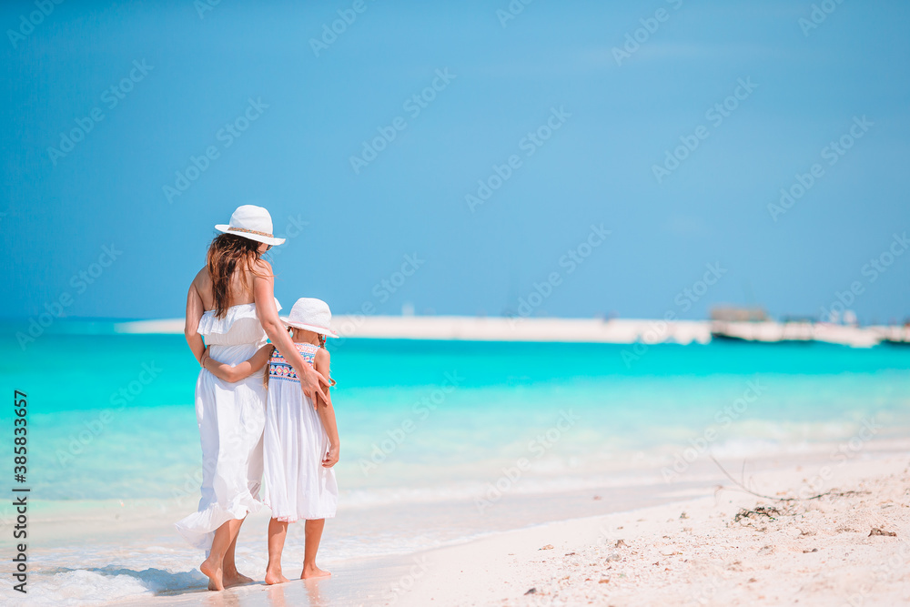 Beautiful mother and daughter at Caribbean beach enjoying summer vacation. Beautiful mother and daughter at Caribbean beach enjoying summer vacation.