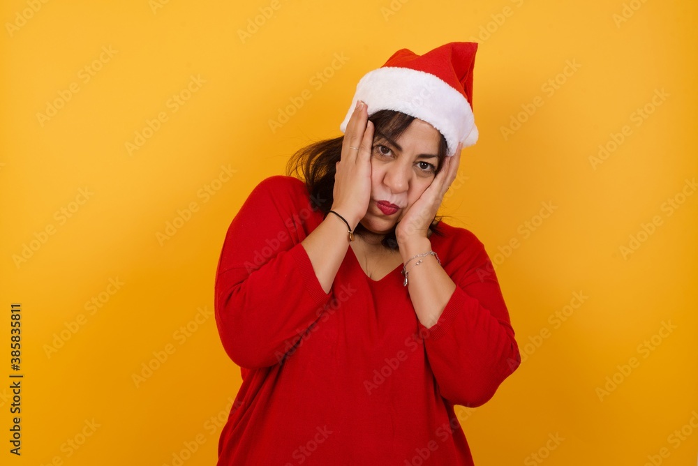 Portrait of beautiful young woman holding head in hands with unhappy expression watching sad movie about animals and trying not to cry. Portrait of beautiful young woman holding head in hands with unhappy expression watching sad movie about animals and trying not to cry.