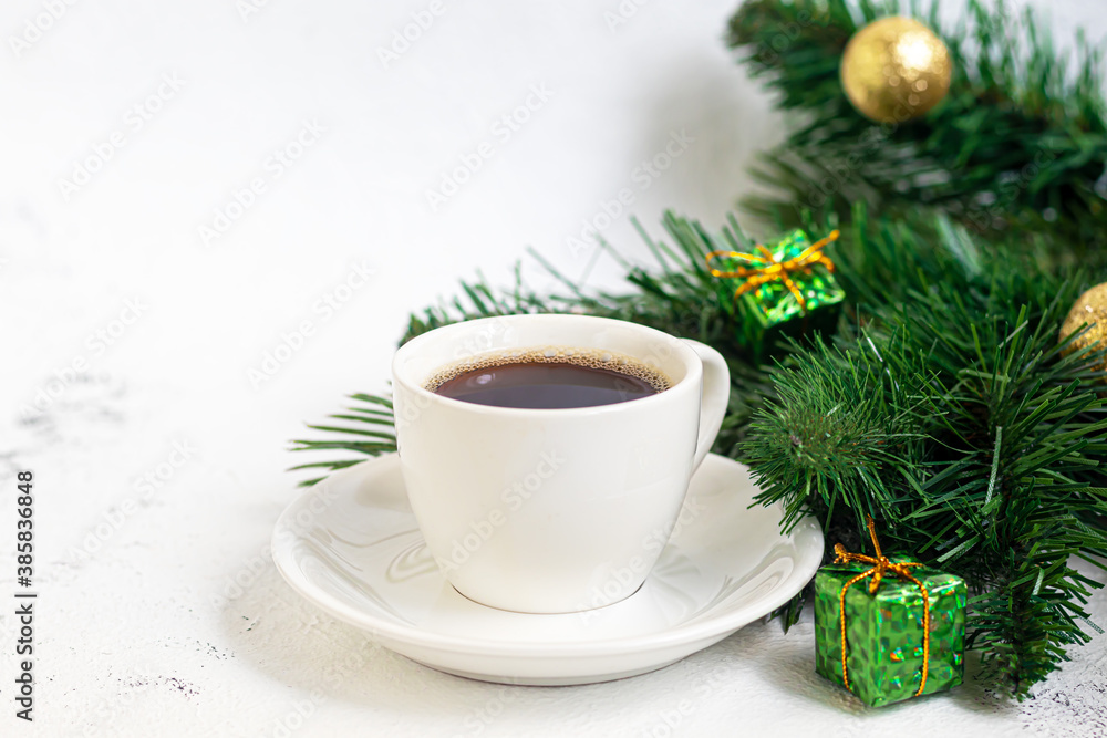 A cup of delicious aromatic coffee. It is placed on a substrate made of coffee beans. New Year holiday concept. On a light background. A cup of delicious aromatic coffee. It is placed on a substrate made of coffee beans. New Year holiday concept. On a light background.