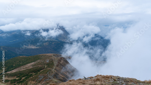 Mountains in the clouds. Hoverla in the Carpathians. Mysterious blue and green mountains. photo from the peak © Nataliia Karabin