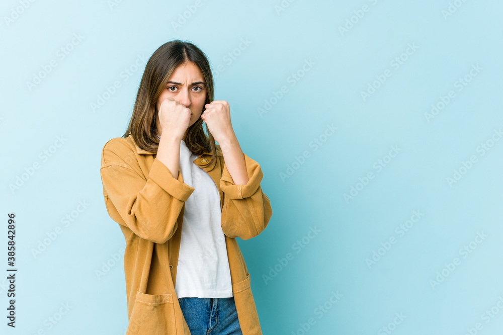 Young caucasian woman throwing a punch, anger, fighting due to an argument, boxing. Young caucasian woman throwing a punch, anger, fighting due to an argument, boxing.