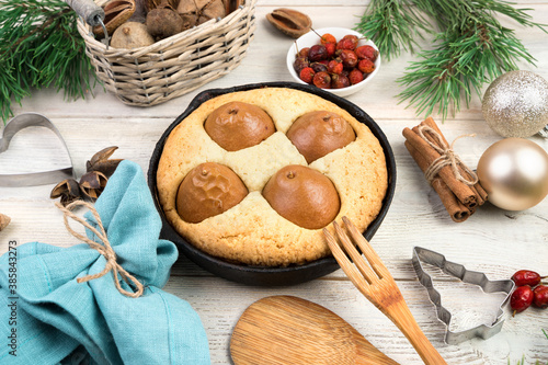 Happy New year and merry Christmas, festive background with cake, cooking utensils and fir decorations on wooden background. Side view. Concept of holiday backgrounds.