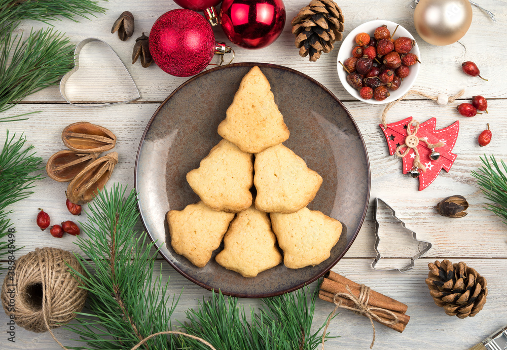 Shortbread cookies on a plate laid out in the shape of a Christmas tree. Horizontal orientation. Concept of holiday backgrounds.