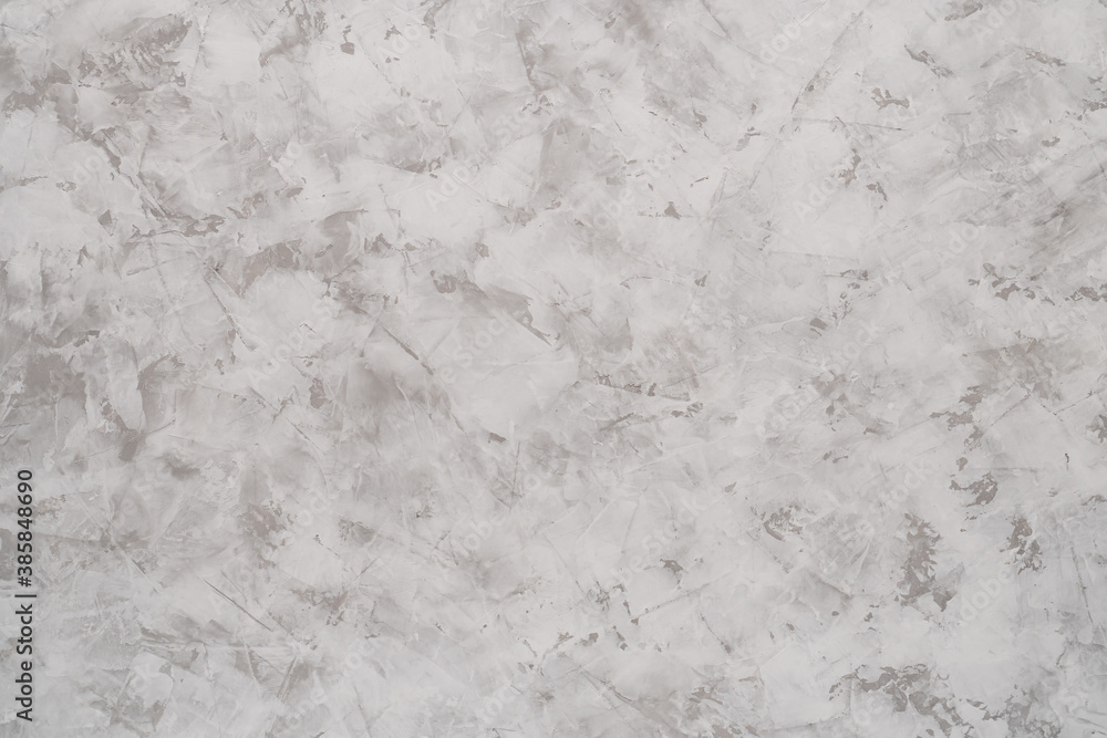 Obraz premium Background of light gray putty or textured gypsum plaster with white stains on the wall.