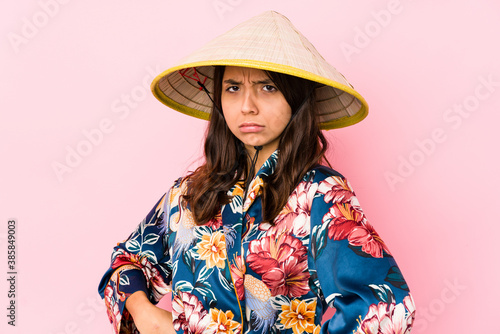 Young mixed race hispanic woman isolated frowning face in displeasure, keeps arms folded.