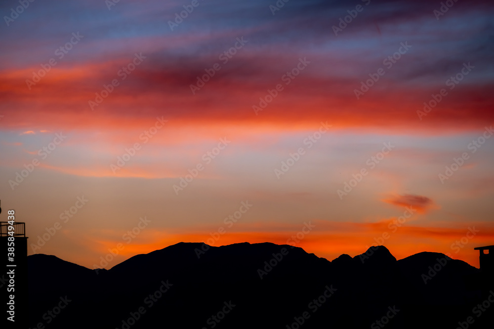 Sunset mountain peaks silhouette. Mountain sunset sky clouds
