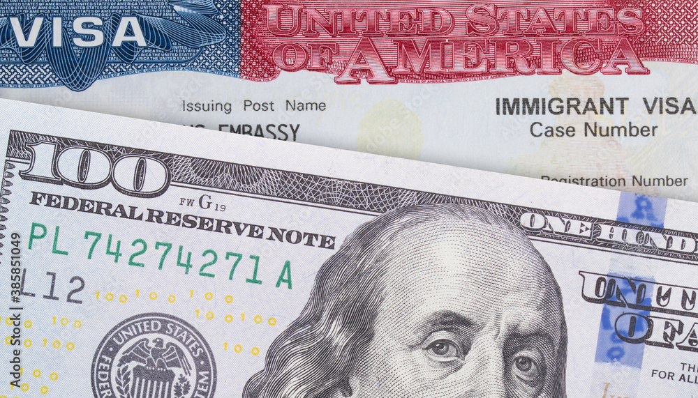 Fototapeta premium VISA United States of America and Money 100 Dollar bill. Work and Travel VISA. Immigration to the USA. Immigration visa. Embassy US or USA. Vacation in the USA. Visa in passport. 