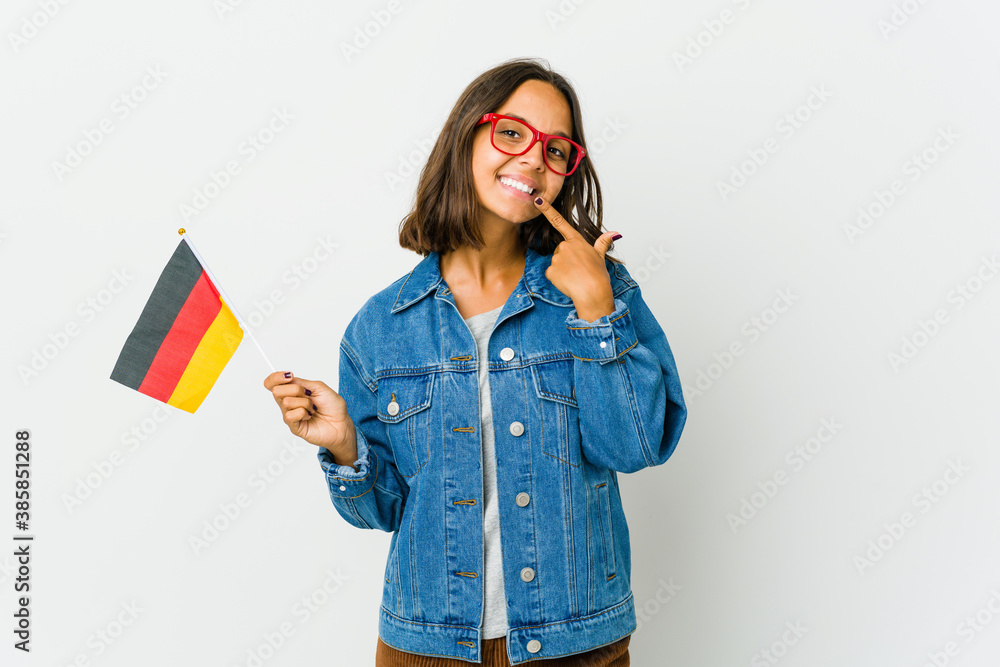 Young latin woman holding a german flag isolated on white background Young latin woman holding a german flag isolated on white background