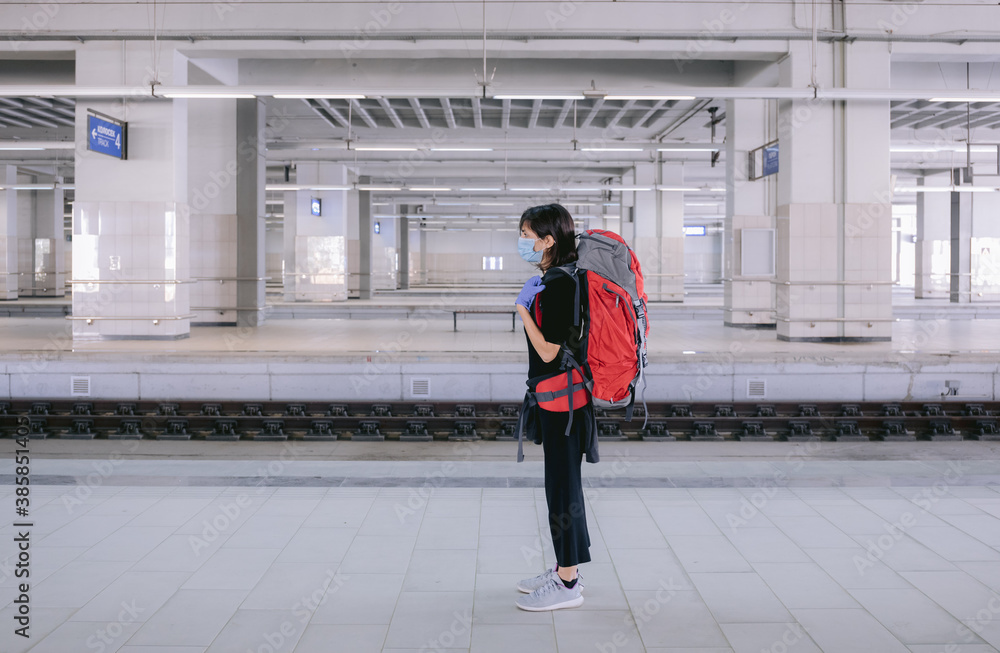 Female traveler wearing protective mask and gloves. Female traveler wearing protective mask and gloves.