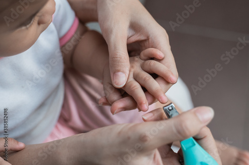 close up of a quiet little boy cutting his nails to make it clean and healthy