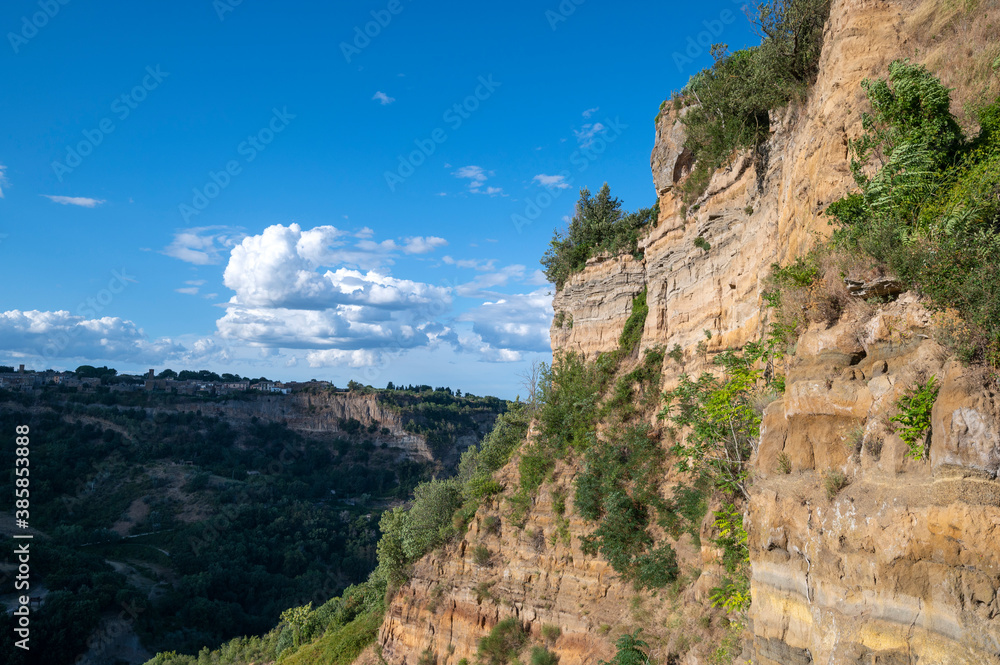 The stratifications of tufa rock at the base of the town of Civita di Bagnoregio, known as the dying city. Civita is is located on the top of a plateau of volcanic origin, Viterbo, Lazio, Italy.