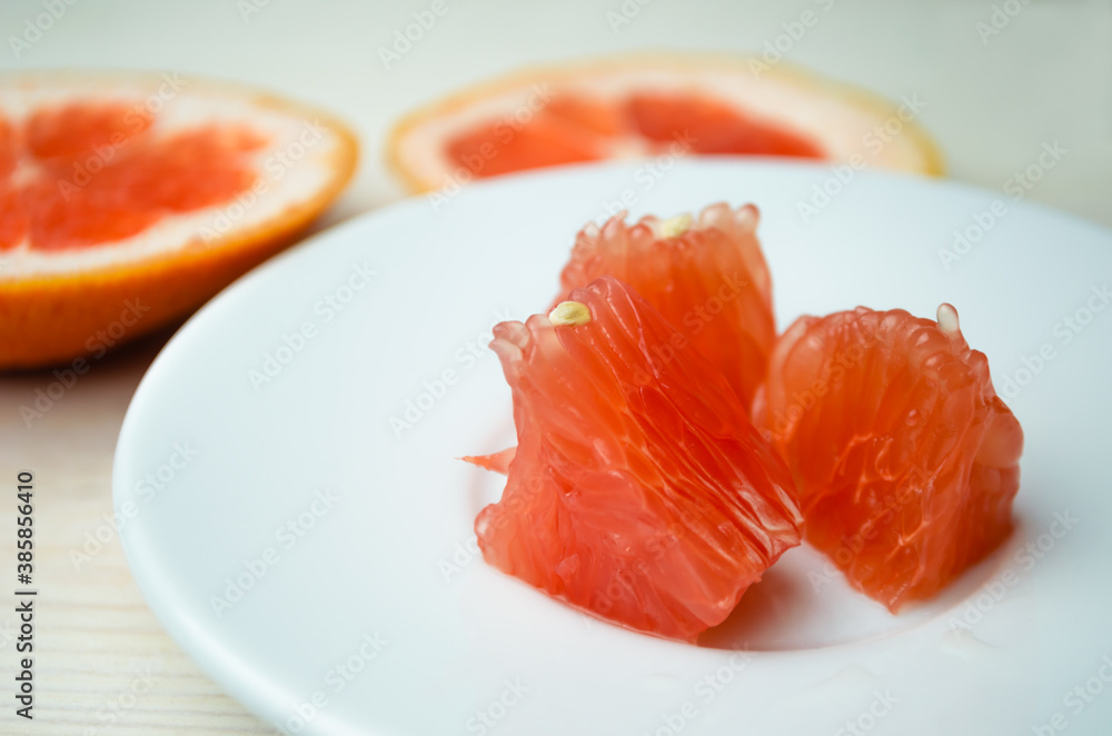 Grapefruit slice on a wooden background. The concept of vegetarianism and raw food. Grapefruit slice on a wooden background. The concept of vegetarianism and raw food.